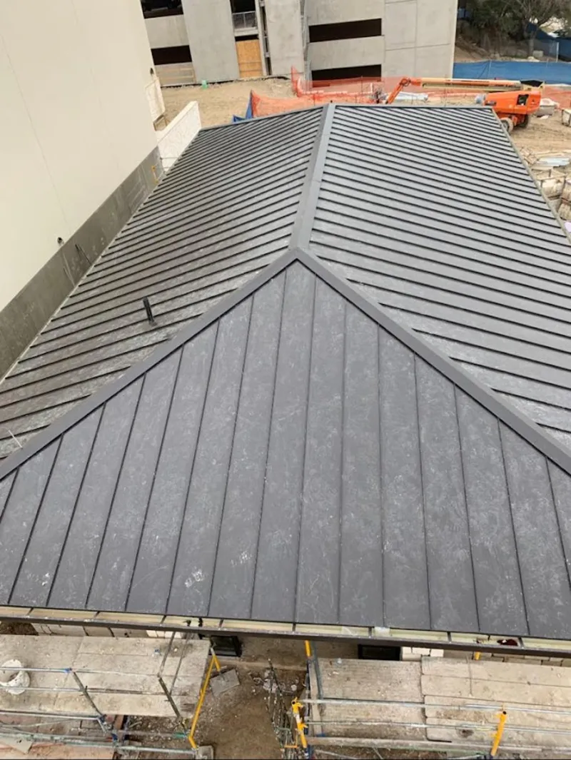 Commercial metal roof construction with crane equipment in American Falls