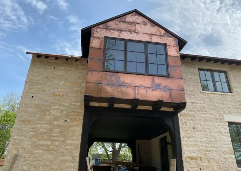 Copper metal panel facade on a stone building for Metal Roof Coating in American Falls